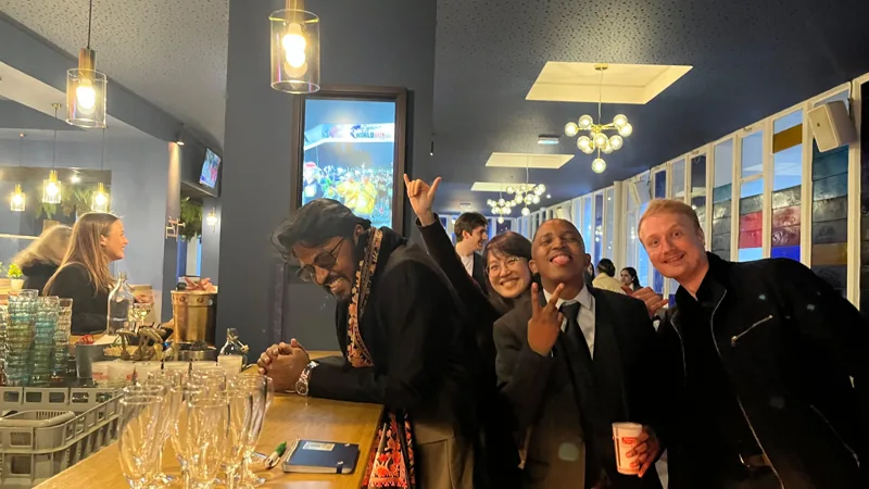 Shivam and friends gathered at a warmly lit bar