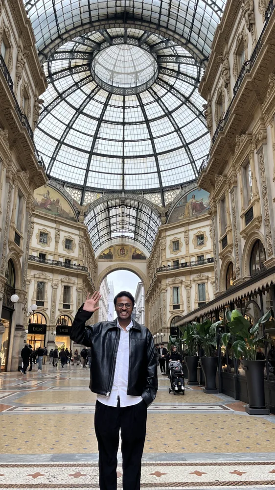 Shivam under an ornate glass-roofed arcade