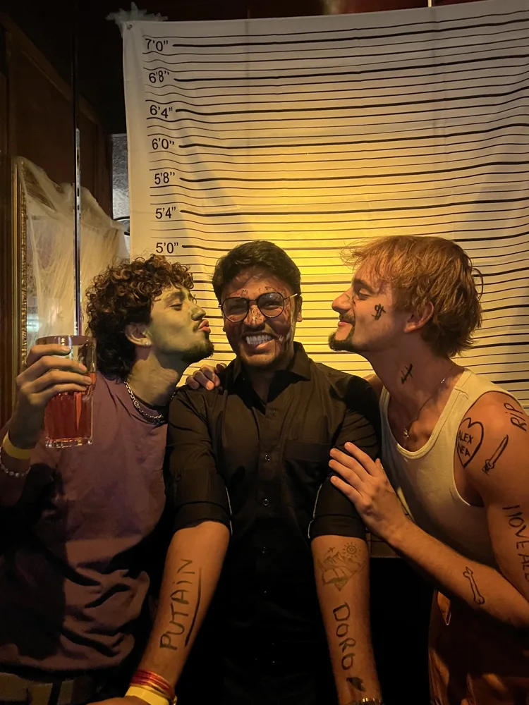 Shivam laughing with two friends during an evening out